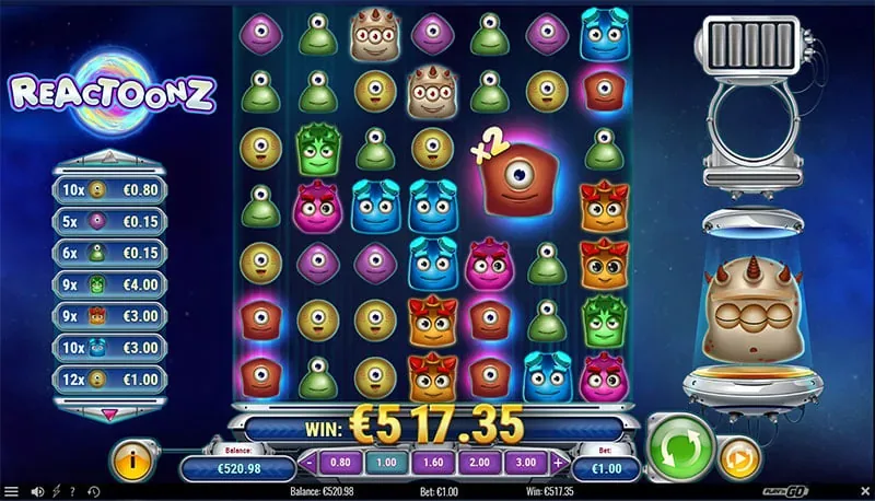Reactoonz 7x7 cluster grid mid-cascade, one-eyed aliens with an x2 multiplier orb and Gargantoon.